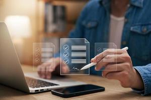 concepto de firma electrónica, empresario de firma electrónica firma documentos electrónicos en documentos digitales en la pantalla de un portátil virtual usando un lápiz óptico. foto