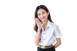 Pretty Asian girl or beautiful young woman student is smiling and looking at camera standing to present something confidently isolated on white background. photo