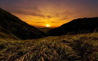 Beautiful mountain sunset panorama with grassland photo