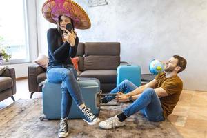young womanwearing sombrero is finishing her make up before leaving photo