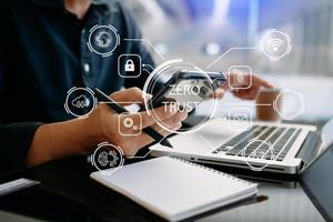 Zero trust security concept Person using computer and tablet with zero trust icon on virtual screen of Data businesses.in modern office photo