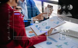 Businessman hand Project manager working and update tasks and Gantt chart scheduling virtual diagram.with smart phone, tablet and laptop photo