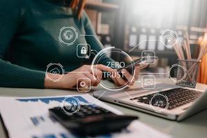 Zero trust security concept Person using computer and tablet with zero trust icon on virtual screen of Data businesses.in office photo