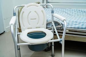 Flush toilet and shower chair in bathroom for old elder people. photo