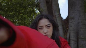 An Asian woman doing a punch martial arts inside the temple at Chinese New Year Festival video