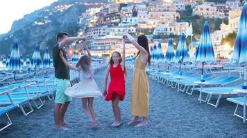 Family in front of Positano on the Amalfi coast in Italy in sunset video