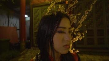 uma mulher chinesa chorando sozinha na frente da flor video
