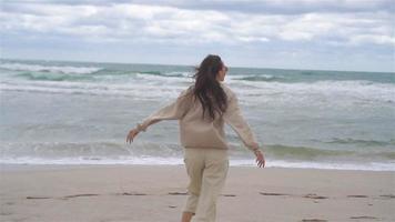 Young woman on the beach in the storm video