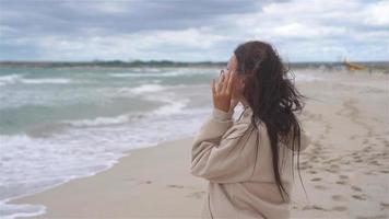 Young woman on the beach in the storm video