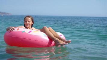Adorable girl on inflatable air mattress in the sea video