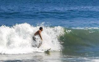 Surfer surfing on surfboard on high waves in Puerto Escondido Mexico. photo