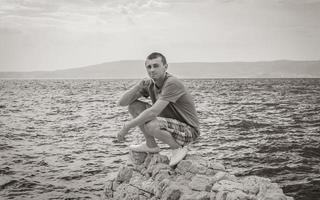 Young male model at Mediterranean landscape in Novi Vinodolski Croatia. photo