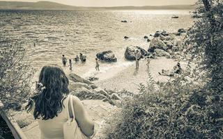 Novi Vinodolski Primorje Gorski Croatia 2012 Tourists go to turquoise water beach seascape Novi Vinodolski Croatia. photo