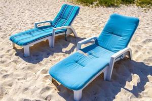 Palms parasols sun loungers beach resort Playa del Carmen Mexico. photo