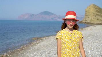 Adorable little girl have fun at tropical beach during vacation video