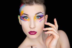 Young adorable brunette with creative make up photo