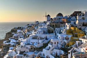 Classic Oia, Santorini skyline at sunset with buildings in Greece. photo