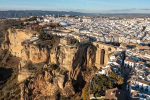 Rocky landscape of Ronda city with Puente Nuevo Bridge and buildings, Andalusia, Spain photo