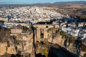 Rocky landscape of Ronda city with Puente Nuevo Bridge and buildings, Andalusia, Spain photo