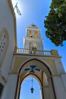 A view of the blue dome and bell tower with clock of the Panagia ton Eisodion church in the traditional village of Megalochori. photo