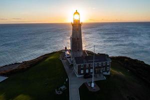 Montauk Lighthouse and beach at sunrise, Long Island, New York, USA. photo