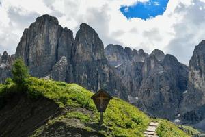 Colors of the Dolomites in the Funes view of the valley in Southern Tyrol, Italy. Green grass, mountains and blue sky. Summer. photo