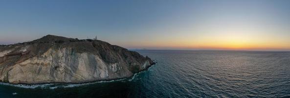 Aerial view of the Akrotiri Lighthouse at sunset in Santorini, Greece. photo