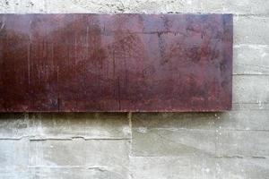 Rusty Metal Plate on Raw Concrete Wall Texture Background. photo