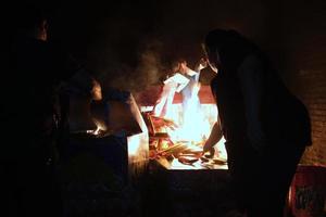 Chinese Servant Paper Doll Burning for Funeral Ritual. photo