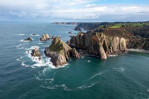 Silence beach, silver-sandy cove backed by a natural rock amphitheatre in Asturias, Spain. photo