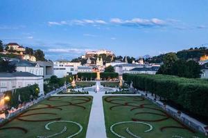 Classic view of famous Mirabell Gardens with historic Hohensalzburg Fortress in the background in the evening in Salzburg, Austria. photo