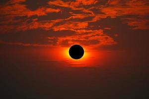 Total solar eclipse on the red orange sky in the morning photo