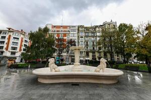 Bilbao, Spain - Nov 26, 2021, Fountain of Lions in Jado Park against a background of the city of Bilbao, Spain. photo