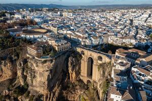 Rocky landscape of Ronda city with Puente Nuevo Bridge and buildings, Andalusia, Spain photo