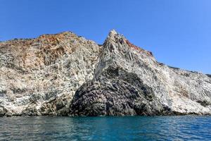 Santorini White Beach with a bright blue sky and the blue sea in Greece. photo