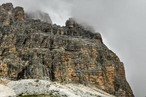 Mountain landscape surrounding Tre Cime park in Italy on a foggy, cloudy, summer, day. photo