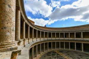 Granada, Spain - Nov 29, 2021, The unique circular patio of the Palace of Charles V  Palacio de Carlos V  with its two levels of columns of Doric and Ionic colonnades, Alhambra, Granada, Spain. photo