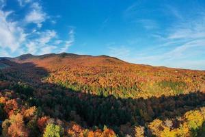 Panoramic view of peak fall foliage in Smugglers Notch, Vermont. photo