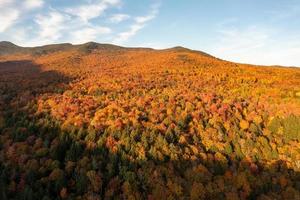 Panoramic view of peak fall foliage in Smugglers Notch, Vermont. photo