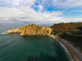 Silence beach, silver-sandy cove backed by a natural rock amphitheatre in Asturias, Spain. photo