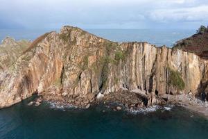 Silence beach, silver-sandy cove backed by a natural rock amphitheatre in Asturias, Spain. photo