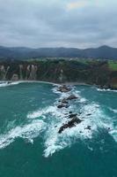 Gueirua beach, located in Asturias, Spain on a cloudy day. photo