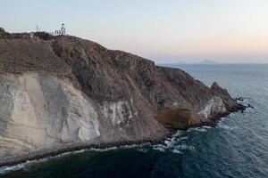 Aerial view of the Akrotiri Lighthouse at sunset in Santorini, Greece. photo