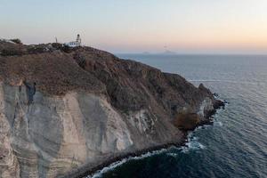 Aerial view of the Akrotiri Lighthouse at sunset in Santorini, Greece. photo