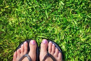 Feet on the grass close-up photo