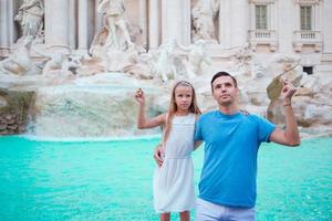 Father and daughter in Trevi Fountain, Rome, Italy photo