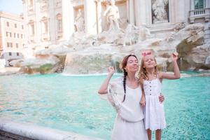 Mother and daughter in Trevi Fountain, Rome, Italy photo
