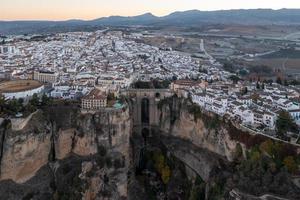 Rocky landscape of Ronda city with Puente Nuevo Bridge and buildings, Andalusia, Spain photo