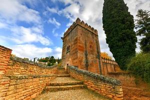 View of the Torre de los Picos, the Tower of the Peaks with the Generalife in the background in the Alhambra in Granada, Spain. photo