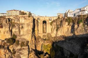 Rocky landscape of Ronda city with Puente Nuevo Bridge and buildings, Andalusia, Spain photo